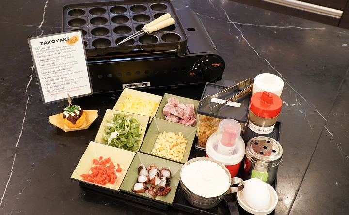 Takoyaki cooking ingredients and tools on the table